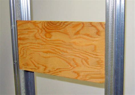 mounting bracket metal studs plywood|plywood blocking in metal studs.